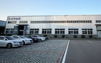 Company building with vehicles parked outside